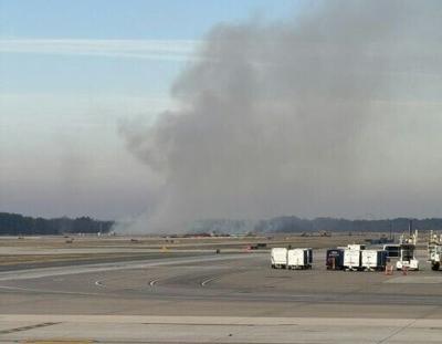 Brush burns near a runway at Dulles Airport outside Washington after a plane experienced engine failure during takeoff 