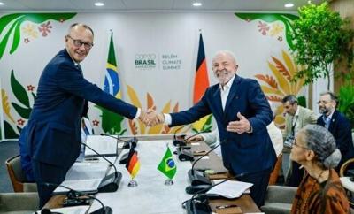 Brazil's President Luiz Inacio Lula da Silva (R) and Germany's Chancellor Friedrich Merz hold a bilateral meeting at COP30