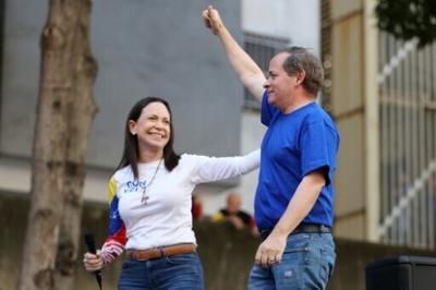 Juan Pablo Guanipa (R), gestures next to Venezuelan opposition leader Maria Corina Machado during a protest in Caracas on January 9, 2025