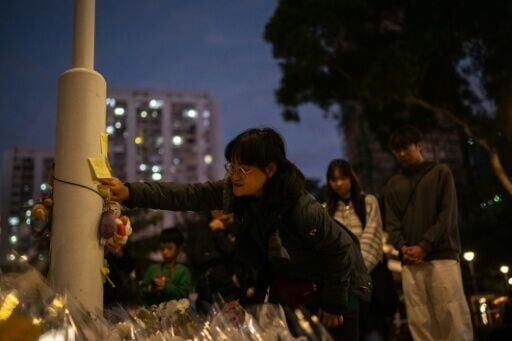 Queues of mourners stretched for hundreds of metres as people arrived at the charred ruins of a residential complex to pay their respects after at least 128 people were killed in Hong Kong's worst blaze in decades