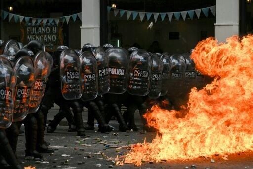 A Molotov cocktail explodes in front of Argentine riot police during a labor reforms debate in the National Congress in Buenos Aires