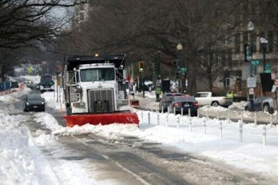 A snowplow works to clear snow on January 28, 2026 in Washington, DC