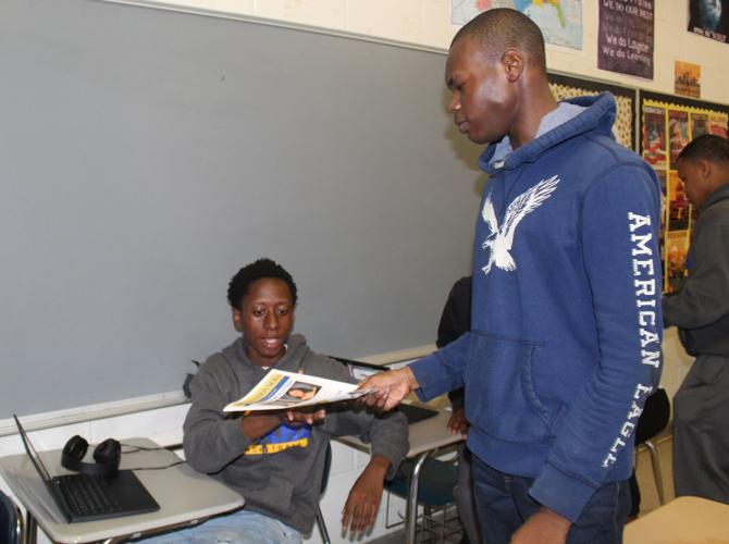 Leeodis handing out paper.JPG