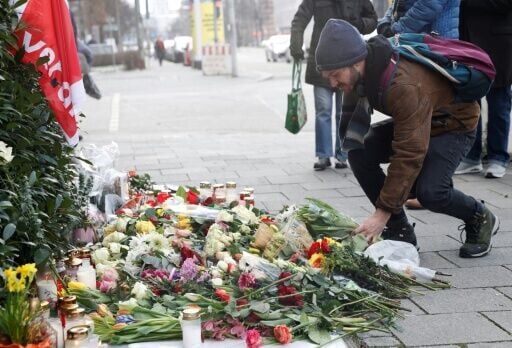 A man lays flowers at the scene of the deadly vehicle attack