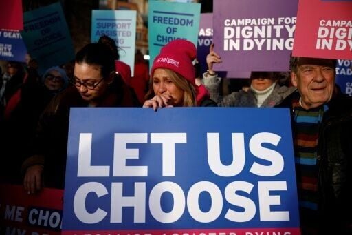 Campaigners supporting the assisted suicide bill hold placards at a 2024 demonstration outside the UK parliament