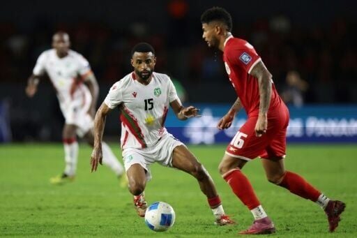 Suriname defender Djavan Anderson (L) in action against Panama in a World Cup qualifier in October