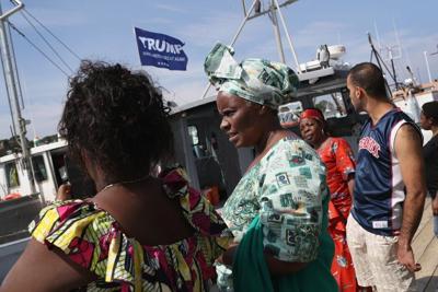 A group of refugees and asylum-seekers tour a commercial fishing marina as part of a summer immersion program in August 2018 in Eastport, Maine.