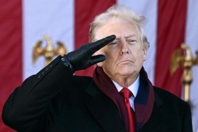 US President Donald Trump salutes at the conclusion of a Veterans Day ceremony at Arlington National Cemetery in Arlington, Virginia on November 11, 2025.