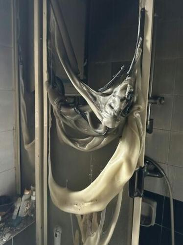 Resident Bowie Chan shared a photo of a plastic shower door hung in melted ribbons from its frame