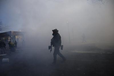 Tear gas fills the air in south Minneapolis on Jan. 24, 2026, after federal agents fatally shot Alex Pretti.