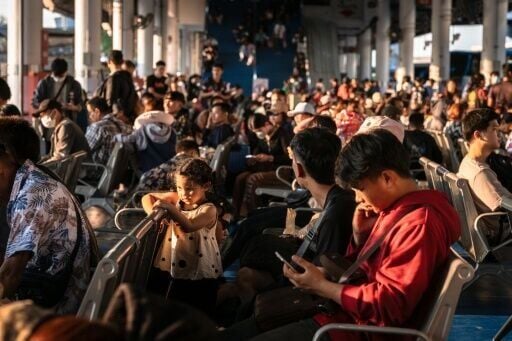 Passengers wait to board a bus as they return to their hometowns from Mo Chit 2 terminal in Bangkok on April 10, 2026 ahead of Thai New Year or Songkran celebrations.