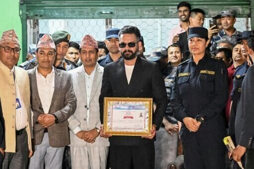 Balendra Shah posed after collecting a certificate for his victory in parliamentary elections