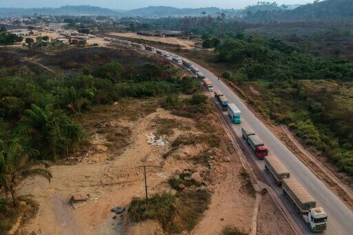 Aerial view of trucks queueing along the BR163 highway in the Amazon rainforest