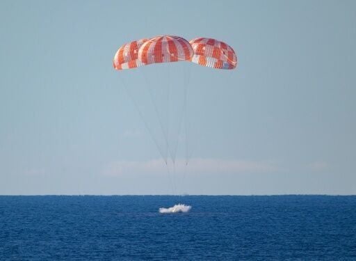 This handout photo released by NASA shows NASA's Orion spacecraft with Artemis II crewmembers aboard as it lands in the Pacific Ocean off the coast of California