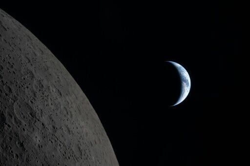 This handout picture released on April 7, 2026, by NASA shows Earth drawing closer to passing behind the Moon, about six minutes before "Earthset," as seen from the Orion spacecraft on April 6, 2026