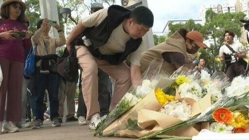 Hongkongers lay flowers for victims of deadly fire