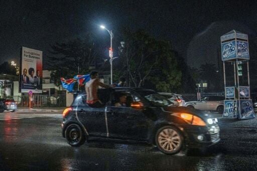Congolese supporters celebrate in the rainy streets of Kinshasa