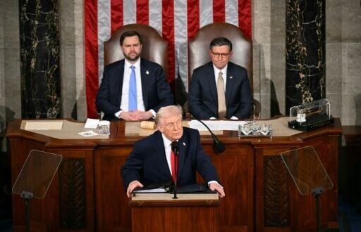 US Vice President JD Vance and Speaker of the House Mike Johnson applaud as US President Donald Trump delivers a record-length State of the Union address