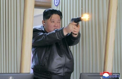 North Korean leader Kim Jong Un test-fires a new pistol at a shooting gallery at an undisclosed location in North Korea.