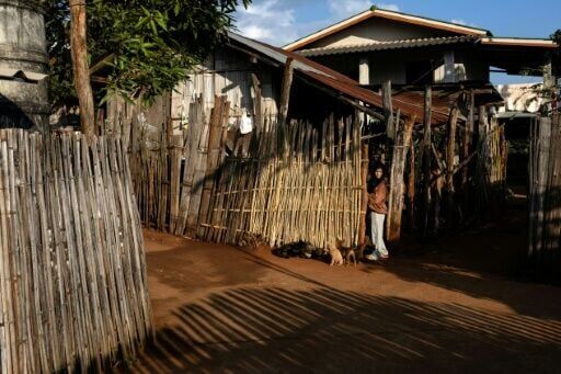 A Lahu girl leaves her home in the village of Muang Na, located just a few kilometres away from the Thai-Myanmar border in Chiang Mai province