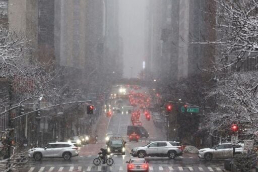 Pedestrians and cars move along 42nd Street in the Manhattan borough of New York City