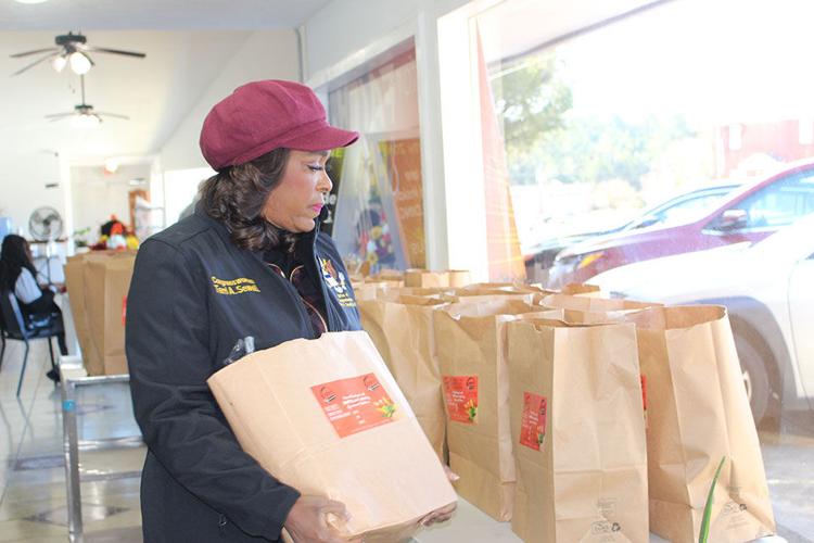 Congresswoman Terri Sewell with a bag of food