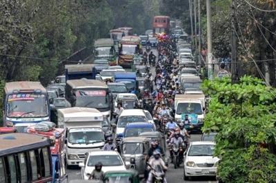 People wait in a queue to refuel their vehicles near a fuel station in Dhaka on March 8, 2026