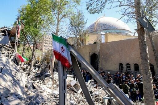 Journalists film outside a damaged mosque following strikes on Sharif University of Technology in Tehran on April 7, 2026
