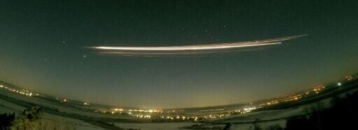 The fireball created by the rocket's upper stage streaking across the sky, seen in a long-exposure image above Berlin