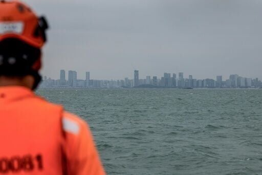 Across a narrow strip of water, the skyline of the Chinese city of Xiamen can be seen from Taiwan