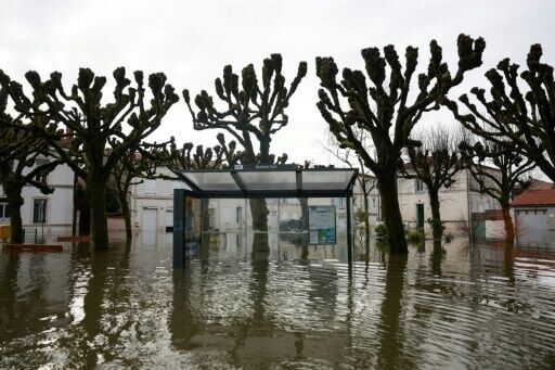 A bus shelter is flooded following heavy rain in the western French town of Saintes