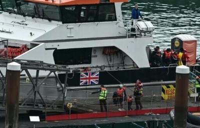 Migrants picked up at sea, including children, disembark from a Border Force vessel in Dover on England's south coast
