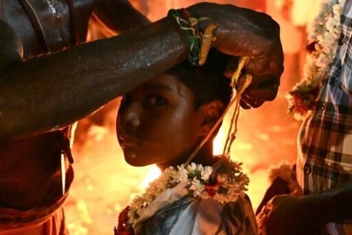 A child takes part in a ritual at the annual Koovagam transgender festival in Tamil Nadu's Kallakurichi district