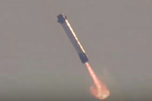 This screen grab taken from a Blue Origin broadcast shows the booster of Blue Origin's New Glenn rocket preparing to land on a floating platform in the Atlantic Ocean