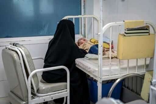Afghan mother Najiba, caring for her ill baby, says 'the only thing I have left is to pray that my child gets better'
