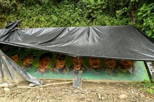 A mural painted by the Jaime Martinez front of FARC dissidents is pictured along a road in the Naya region of Colombia ahead of legislative elections