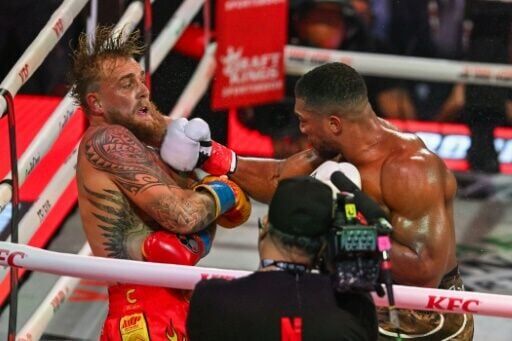Former world heavyweight champion Anthony Joshua lands a blow on Jake Paul before scoring a sixth round knockout in their Netflix-backed fight
