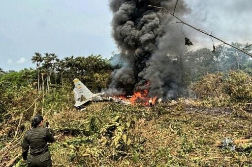 Flames and thick black smoke rise from an Air Force Hercules that crashed during takeoff in Puerto Leguizamo, Colombia, near the southern border with Ecuador