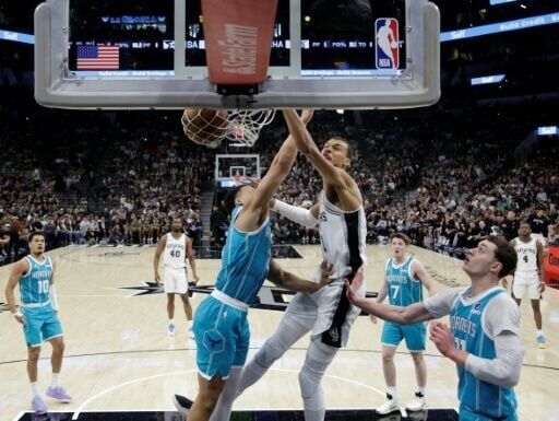 San Antonio's Victor Wembanyama dunks in the Spurs' NBA victory over Charlotte