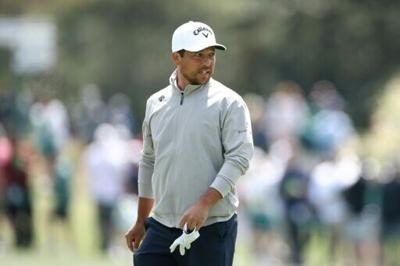 Two-time major winner Xander Schauffele watches at the 15th green during a practice round ahead of the 90th Masters