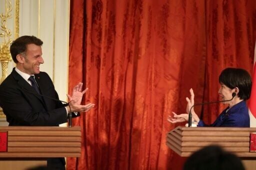 In a lighthearted moment, Macron and Takaichi do the 'kamehameha' gesture from the popular manga 'Dragon Ball'