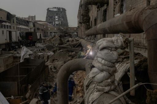 Employees repair sections of the Darnytska combined heat and power plant damaged by Russian air strikes in Kyiv, on February 4, 2026, during the Russian invasion of Ukraine. Recent Russian strikes on Ukraine's power infrastructure have disrupted light, ...
