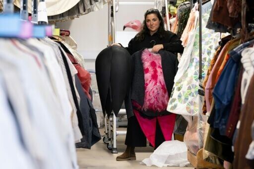 Head of Costume Workshops at the Geneva opera house Sandra Delpierre displays a bird tailcoat suit adorned with real pink-dyed feathers by Greek director and designer Yannis Kokkos