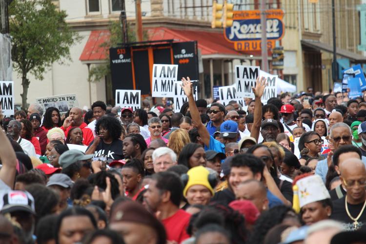 I am Man signs with arms up at Jubilee