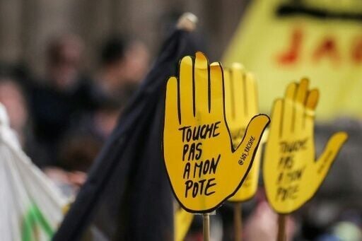 Some protesters hel placards reading 'Don't touch my mate', the slogan of the anti-racist group SOS Racisme