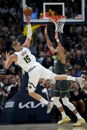 Nikola Jokic of the Denver Nuggets puts up a shot against Rudy Gobert in the Nuggets' win over the Minnesota Timberwolves in their NBA playoff opener