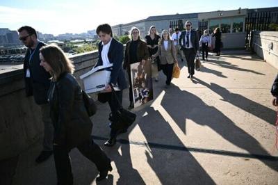 Reporters carry their belongings from the Pentagon on October 15, 2025 after news outlets including AFP, AP, The New York Times and Fox News declined to sign new restrictive Pentagon media rules, and were stripped of their press access credentials