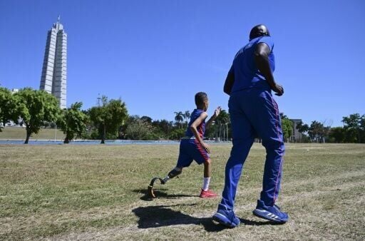 Juan Jose Guilarte jogs with his coach during a pentathlon training session