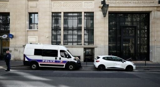 Police and private security vehicles outside the Bank of America building in Paris's chic 8th arrondissement