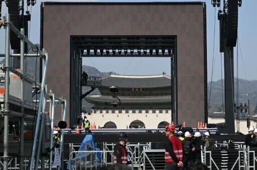 Workers set up the stage for the comeback concert of K-pop boy group BTS at Gwanghwamun Square in Seoul on March 20, 2026.